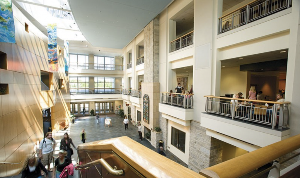 Students walking through a multi-level open space inside Buntrock Commons