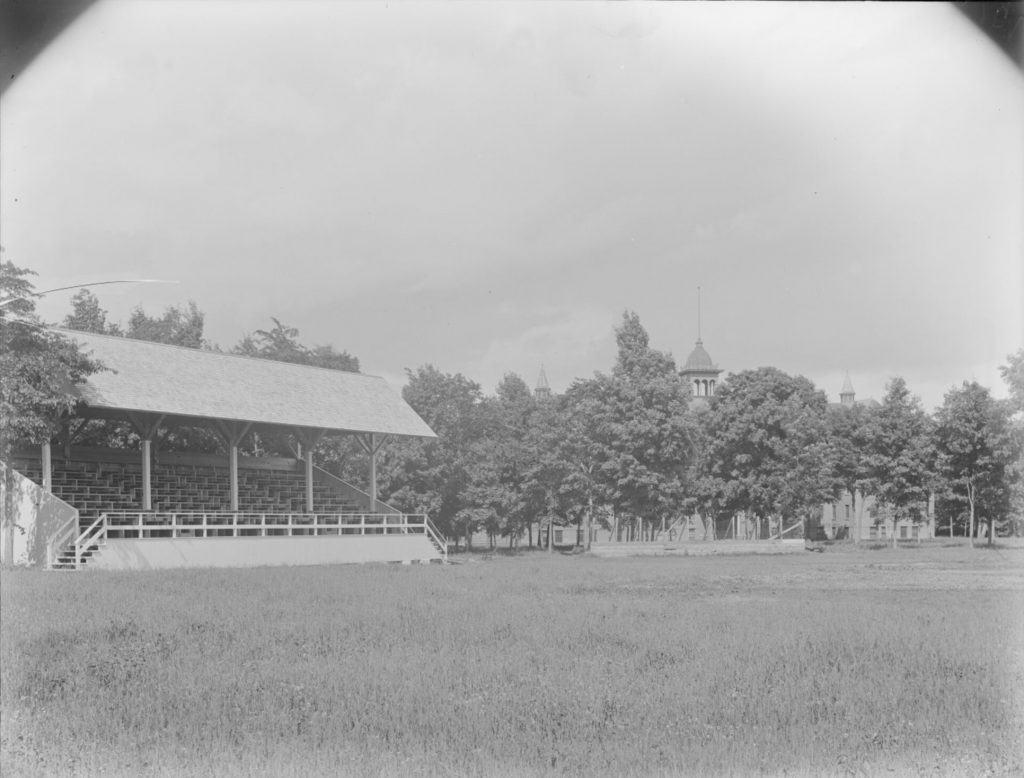 Covered bleachers next to an open field