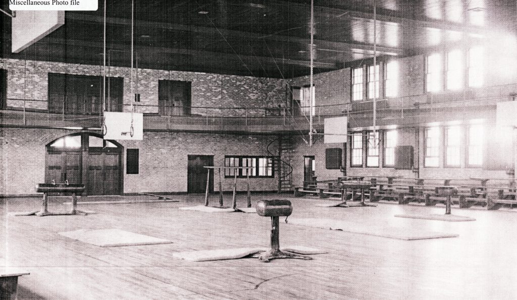 Interior of old gymnasium, including gymnastics equipment