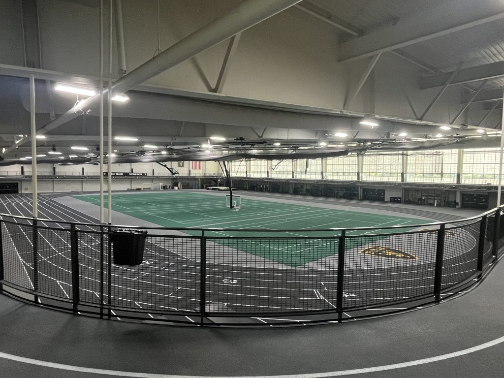 Indoor tracks circling multi-sport practice courts