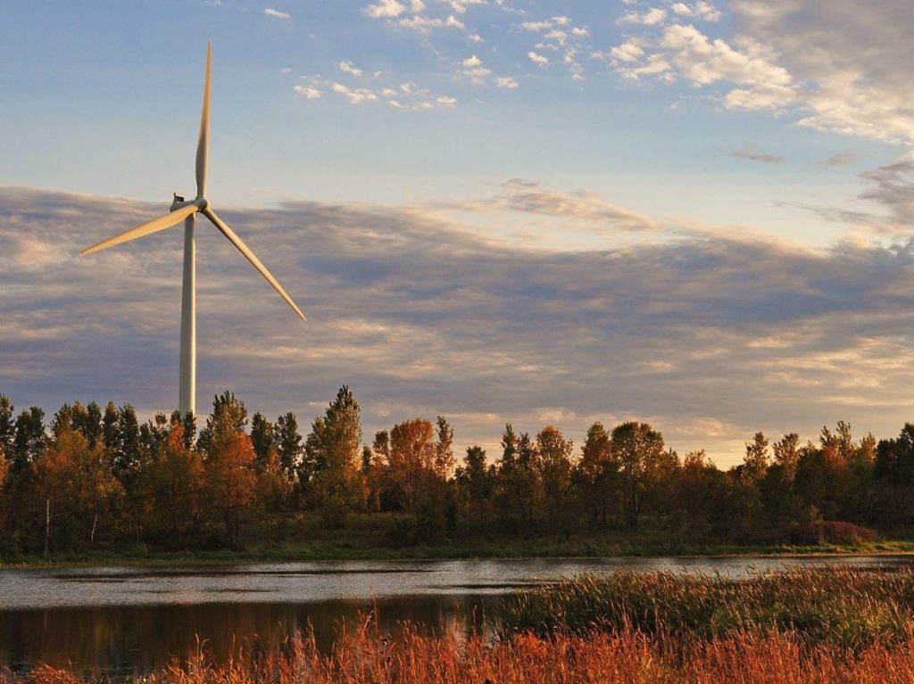 Windmill behind natural landscape
