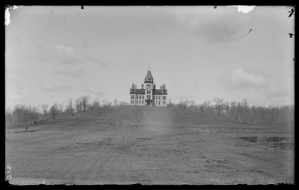 Old Main, far away in a large open field