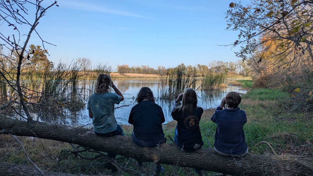 St. Olaf student naturalists bird watching on Big Pond in the Natural Lands.